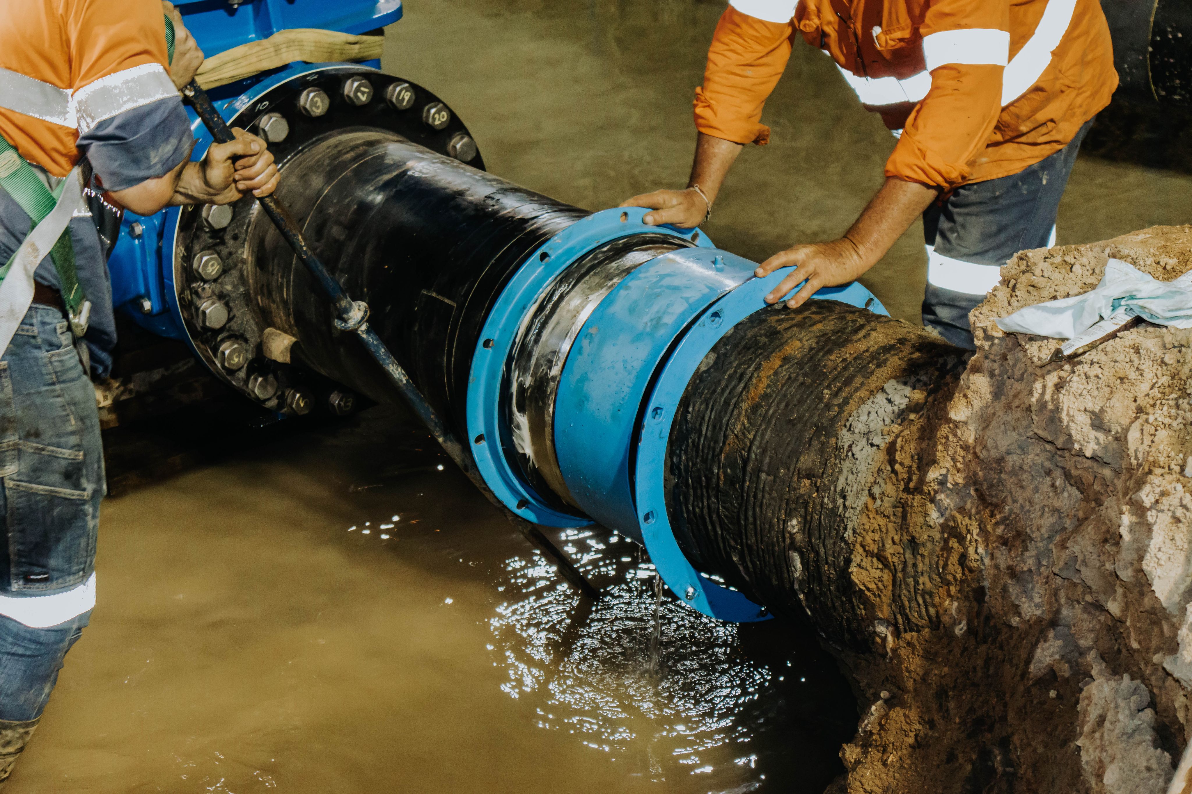 Crew installing a large water pipeline connection